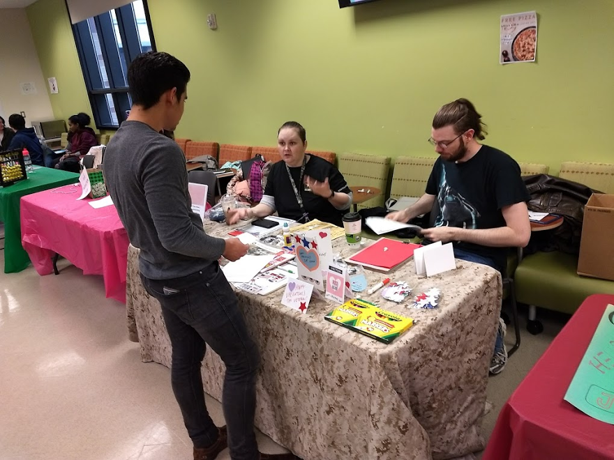 Student veterans make cards for veterans in a local retirement home.